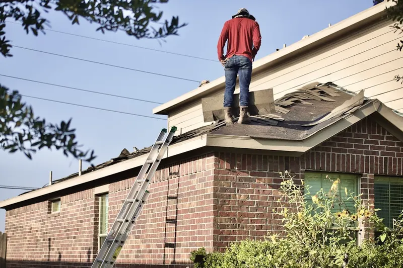 Professional roofer working on a residential roof in Golden Acres Estates